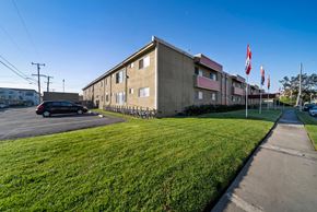 Hawthorne apartment for rent - A building with a green lawn in front of it.