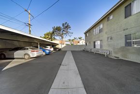Hawthorne apartment for rent - A parking lot with cars parked and a building on the right.