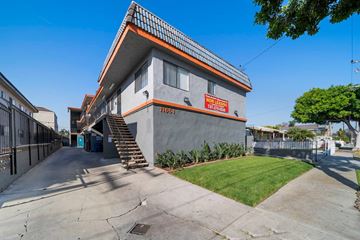Hawthorne apartment for rent - A modern house with a grey and orange exterior and a blue door.