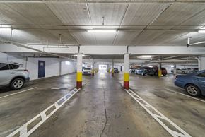 Hawthorne apartment for rent - A parking garage with cars parked on both sides of the aisle.