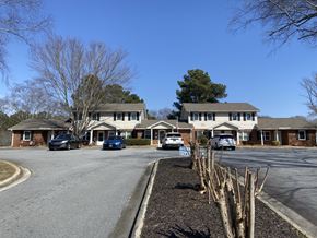 Newnan apartment for rent - A car is parked in front of a house.
