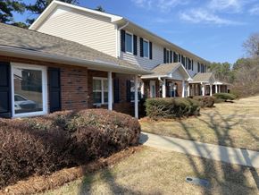 Newnan apartment for rent - A row of houses with a clear blue sky above them.