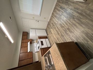 Newnan apartment for rent - A kitchen with a stove top oven and a sink.