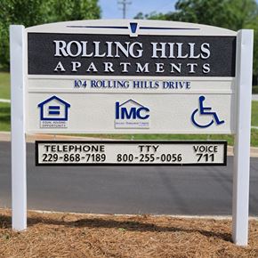 Newnan apartment for rent - A sign for Rolling Hills Apartments with contact information and logos.