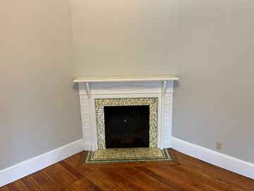 Andover apartment for rent - a fireplace in a living room with a rug
