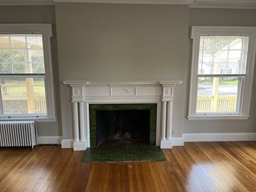 Andover apartment for rent - a living room with a fireplace and a green rug