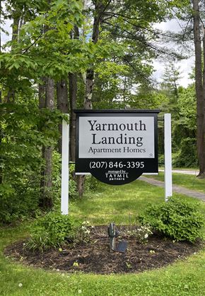 Yarmouth apartment for rent - a sign for yarmouth landing apartment homes in front of trees