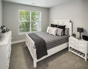 Freeport apartment for rent - A bedroom with a large bed and a window with blinds.
