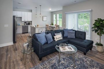 Freeport apartment for rent - A modern living room with a black sofa and a glass coffee table.
