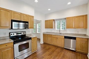 Concord apartment for rent - a kitchen with wooden cabinets and stainless steel appliances