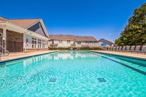 Charlotte apartment for rent - A swimming pool in a residential area with houses in the background at The Atlantic Mountain Island, Charlotte