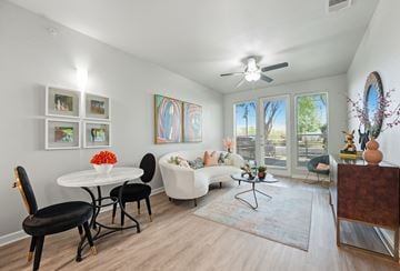 Dallas apartment for rent - A living room with a white couch, a white table, and a painting on the wall.