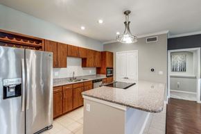 Houston apartment for rent - Kitchen with granite countertops and wooden cabinets at Vintage Park Apartments, Houston