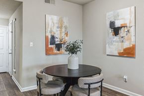 Cary apartment for rent - a dining room with paintings on the wall and a table with chairs  at Harrison Grande, Cary, NC, 27513