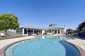 San Antonio apartment for rent - A large swimming pool in front of a house at The Atlantic Stone Oak Apartments, San Antonio, TX.