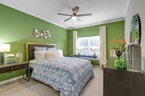 Atlanta apartment for rent - A bedroom with a bed, a ceiling fan, and a mirror at The Atlantic Buckhead Apartments, Atlanta, GA, 30305