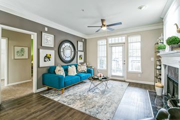 Atlanta apartment for rent - A living room with a blue couch and a rug.