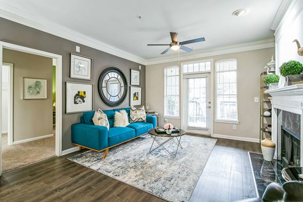 Atlanta apartment for rent - A living room with a blue couch and a rug at The Atlantic Buckhead Apartments, Georgia