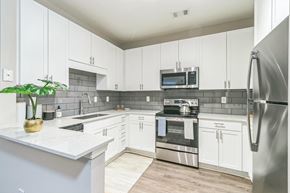 Atlanta apartment for rent - Kitchen with white cabinets at The Atlantic North Highland, Charlotte