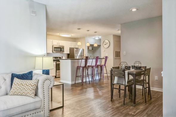 Charlotte apartment for rent - an open living room and kitchen with a dining room table and chairs at Magnolia Terrace Apartments, Charlotte, North Carolina