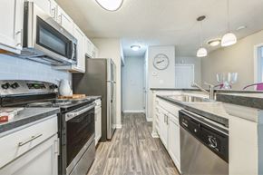 Charlotte apartment for rent - an open kitchen with stainless steel appliances and white cabinets at Magnolia Terrace Apartments, North Carolina