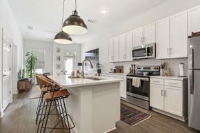 Decatur apartment for rent - Open kitchen with white cabinets and a large island at Arcadia Decatur, Decatur, GA.