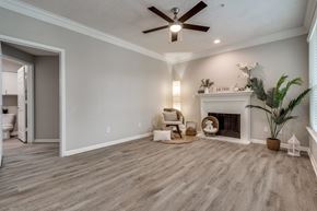 Houston apartment for rent - A living room with a fireplace and a ceiling fan. at Montecito Apartments, Texas, 77056
