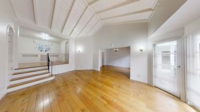 Berkeley apartment for rent - A spacious room with wooden floors and white walls.