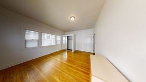 Berkeley apartment for rent - A room with wooden floors and white walls.
