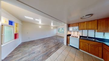 Berkeley apartment for rent - A kitchen with wooden cabinets and a white dishwasher.