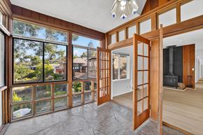 Berkeley apartment for rent - A room with a large window and a view of a backyard.