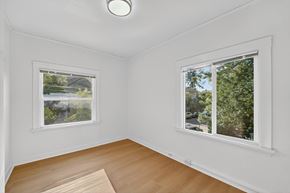 Berkeley apartment for rent - A room with a window showing a view of a street and trees.