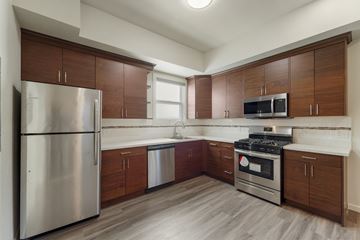 Berkeley apartment for rent - A kitchen with wooden cabinets and stainless steel appliances.