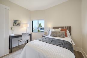 Berkeley apartment for rent - A bedroom with a large bed and a desk with a chair.