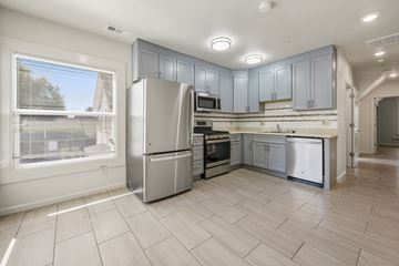Berkeley apartment for rent - A kitchen with a refrigerator, oven, and microwave.
