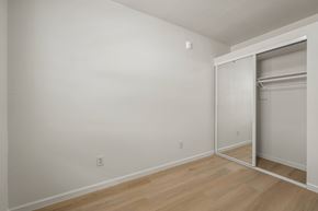 Berkeley apartment for rent - A room with a white wall and a wooden floor.