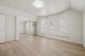 Berkeley apartment for rent - A room with a white door, a mirror, and a window with blinds.
