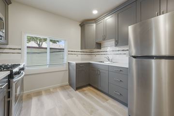 Berkeley apartment for rent - A modern kitchen with a stainless steel refrigerator and wooden flooring.