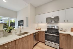 Berkeley apartment for rent - A modern kitchen with wooden cabinets and stainless steel appliances.