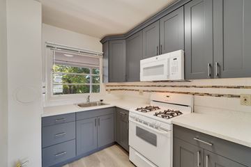 Berkeley apartment for rent - A kitchen with a white stove and a white microwave.