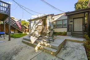 Berkeley apartment for rent - A patio with a table and chairs is in front of a house.