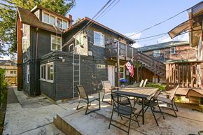 Berkeley apartment for rent - A patio with a table and chairs is in front of a house.