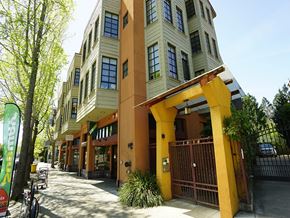 Berkeley apartment for rent - A yellow and brown building with a gate in front.