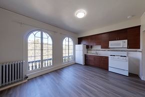 Berkeley apartment for rent - A kitchen with white appliances and wood cabinets.