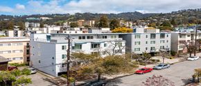 Berkeley apartment for rent - A parking lot with cars and apartment buildings in the background.
