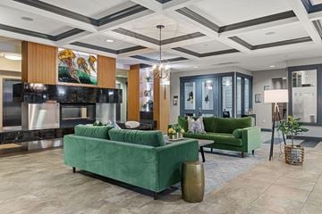 Tacoma apartment for rent - A living room with a green couch and a painting on the wall.
