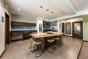 Seattle apartment for rent - A kitchen with a bar area and a refrigerator.