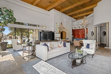 Katy apartment for rent - A modern living room with a white sofa and a glass coffee table.