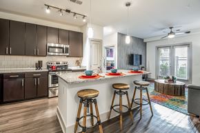 Atlanta apartment for rent - A kitchen with a white countertop and wooden bar stools.