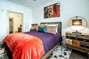 Atlanta apartment for rent - A bedroom with a bed, a dresser, and a painting on the wall.